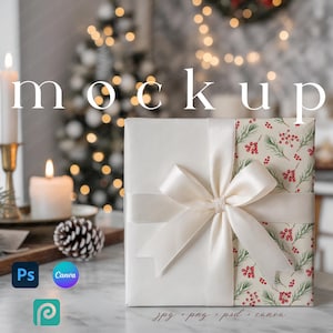 May include: A wrapped gift with a cream-colored bow. The gift is wrapped in white paper with a section of patterned paper featuring green pine needles and red berries. The word "mockup" is displayed in the background.