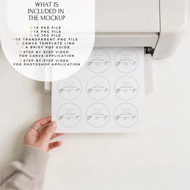 May include: A printer is shown with a sheet of round stickers being printed. The stickers have a light blue border and text that reads "Ashley & Dave". The text "WHAT IS INCLUDED IN THE MOCKUP" is at the top left, listing file types and video guides.