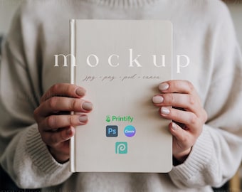 May include: A white mockup book with the word "mockup" printed in black text. The book also has the text "jpg - png - psd - canva" printed in black text. The book is being held by a person's hands. The book also has logos for Printify, Photoshop, Canva, and Pinterest.