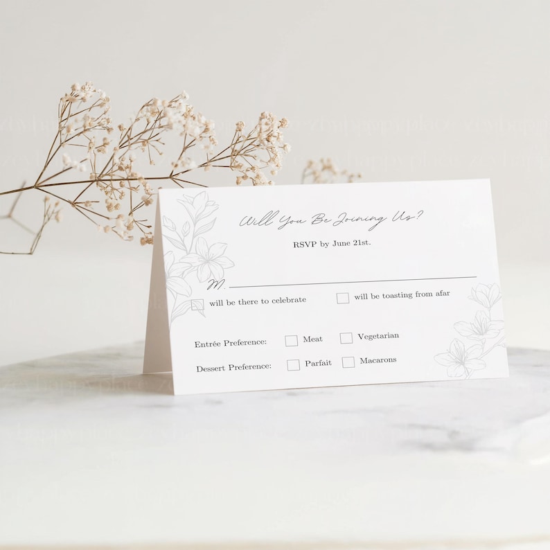 May include: A white RSVP card with a floral design and the text "Will You Be Joining Us?" RSVP by June 21st.  The card has checkboxes for guests to indicate their attendance and meal preferences.  The options include "will be there to celebrate", "will be toasting from afar", "Meat", "Vegetarian", "Parfait", and "Macarons".