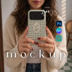 May include: A phone case with a green and white gingham pattern and a floral design. The case is held up in front of a person. The word "mockup" is displayed in the image.