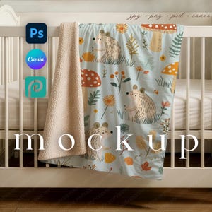May include: A baby blanket with a light blue background featuring a whimsical pattern of hedgehogs, mushrooms, and flowers. The blanket has a soft, plush, cream-colored backing. The word "mockup" is displayed on the blanket.