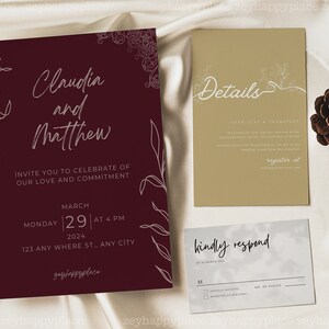 May include: Burgundy wedding invitation with white calligraphy for Claudia and Matthew. The invitation includes the date, time, and location of the wedding. A separate card with details about the wedding is also included, along with a response card.