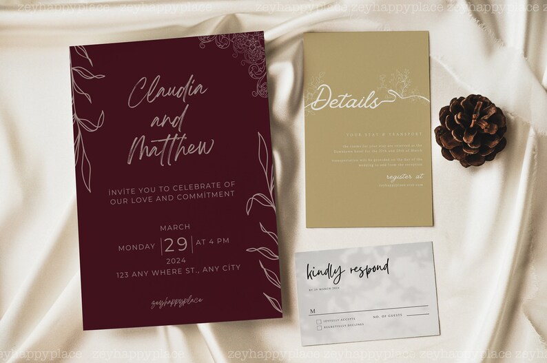 May include: Burgundy wedding invitation with white calligraphy for Claudia and Matthew. The invitation includes the date, time, and location of the wedding. A separate card with details about the wedding is also included, along with a response card.