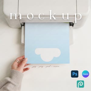 May include: A light blue paper with a white cloud design is being printed from a white printer. The word "mockup" is printed at the top. The bottom of the paper has the text "jpg . png . psd . canva".