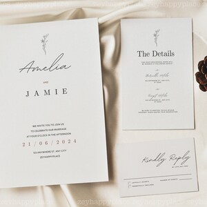 May include: A wedding invitation suite with a minimalist design. The main invitation features a simple floral illustration and the names Amelia and Jamie. The details card includes the date, time, and location of the wedding. The RSVP card has a simple "Kindly Reply" message.