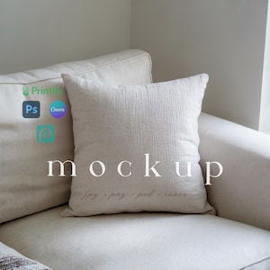 May include: A white linen pillow sits on a white couch. The pillow is textured and has a subtle sheen. The word "mockup" is printed in white on the pillow.