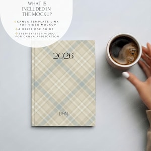 May include: A hardcover planner with a beige, blue, and white plaid pattern. The year "2026" is printed in black at the top, with the name "DAN" below. A cup of coffee sits next to the planner.