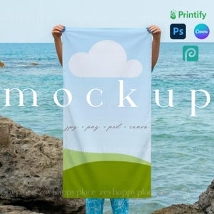 May include: A light blue beach towel mockup with a white cloud design and green and blue accents. The word "mockup" is displayed in large white letters. The towel also features the text "jpg + png + psd + canva".