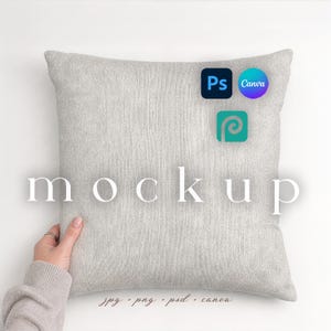 May include: A square, light gray pillow with the word "mockup" printed on it. The pillow is being held by a person. The image also includes the logos for Photoshop, Canva, and Placeit, along with the file types: jpg, png, psd, and canva.