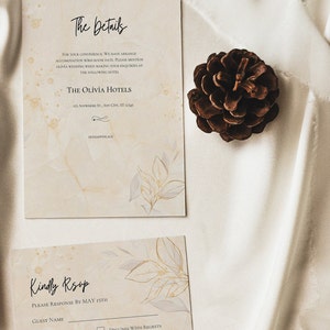 May include: A beige wedding RSVP card with a floral design. The card has a section for the guest's name, a checkbox for happily accept, a checkbox for declines with regrets, and a space for dietary requirements. The text "Kindly RSVP" and "Please response by May 15th" is printed on the card.