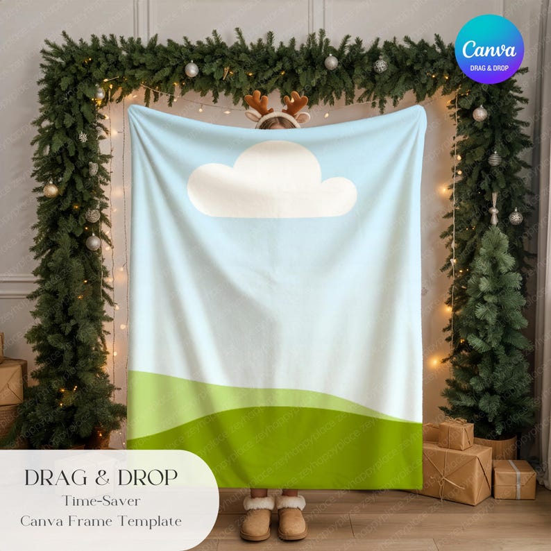 May include: A light blue blanket with a white cloud design and green hills at the bottom. The blanket is held up in front of a Christmas tree and garland. Text at the bottom reads "DRAG & DROP Time-Saver Canva Frame Template."
