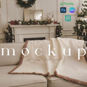 May include: A cream-colored waffle-weave blanket with a fringed edge, draped over a beige sofa. The blanket has a textured appearance and a decorative border with red, brown, and green hues. The word "mockup" is displayed in large white letters.