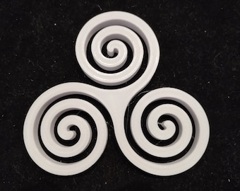 May include: White plastic three-dimensional triquetra symbol with three interlocking spirals.