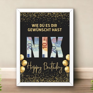 May include: A black and gold framed poster with the text "Wie du es dir gewünscht hast NIX Happy Birthday" with the word "NIX" made of euro bills.