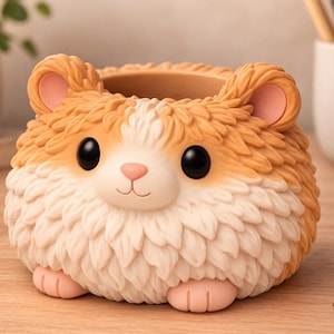 May include: A whimsical hamster-shaped planter in shades of orange, white, and pink. The ceramic pot features large black eyes, pink ears, and paws, creating a charming, cartoonish design. Ideal for small plants or as a desk organizer.