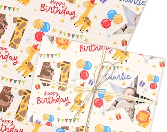May include: Birthday wrapping paper featuring a repeating pattern of cartoon animals, balloons, and the text "Happy Birthday." The design includes a giraffe, lion, and bear, with the number "1" and the name "Charlie" visible.