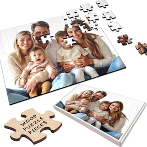 May include: A wooden jigsaw puzzle featuring a photo of a family of five. The puzzle is assembled on a white surface with the box visible in the background. The puzzle piece in the foreground has the text "WOOD PUZZLE PIECES" printed on it.