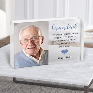 May include: A clear acrylic block memorial with a photo of a man and a blue heart. The text reads "Grandad, If tears could build a stairway to heaven, I would walk right up and bring you back again. 1950 - 2048."