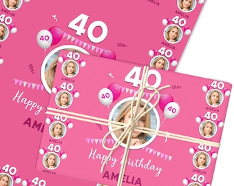 May include: Pink birthday wrapping paper with a photo of a woman, the number 40, and the name Amelia. The design includes balloons, a banner, and the words "Happy Birthday".