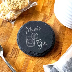 May include: Black slate coaster with the text "Mum's Gin" and a drawing of a glass of gin with a lemon slice.