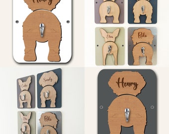Puede incluir: Conjunto de seis ganchos de madera con forma de trasero de perro con nombres personalizados. Los ganchos son de varios colores y tienen un gancho plateado. Los nombres son "Henry", "Cookie", "Sandy", "Elvis" y "Rolo".