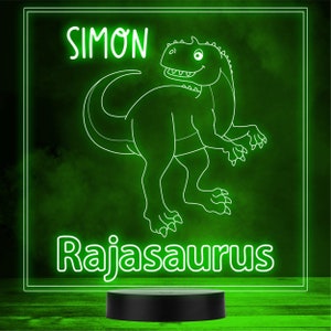 May include: A green neon sign with a white outline of a dinosaur and the text "Simon Rajasaurus".