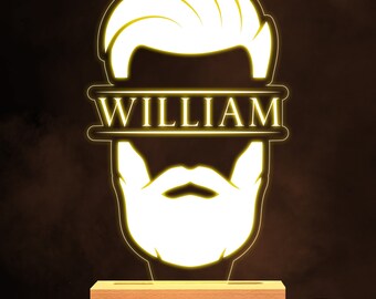 May include: A yellow illuminated night light shaped like a man's face with a beard and a hairstyle. The name "WILLIAM" is written across the top of the light.