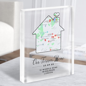 May include: A white acrylic block with a map of Wimbledon, London, inside a house shape. The text "Our Forever Home" is written in black cursive script with the date "23.09.22" below. The address "12 Worple Road, Wimbledon, London" is printed below the date.