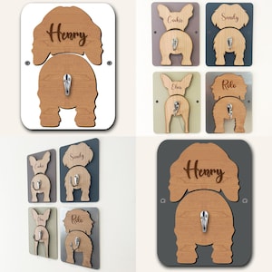 May include: Set of six wooden dog-shaped coat hooks with personalized names. The hooks are in various colors and feature a metal hook on the back. The names on the hooks are Henry, Cookie, Sandy, Elvis, and Rolo.