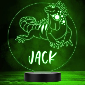 May include: Green neon night light with a cartoon iguana and the name "JACK" underneath. The light is on a black base.