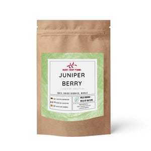 May include: A brown paper bag of juniper berries. The bag features a green label with the words "Juniper Berry" in bold black letters. The label also includes the text "100% Dried Berries, Whole" and "Wild Grown - Wild by Nature."