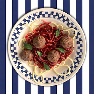 May include: A plate of spaghetti with red sauce, four meatballs, and basil leaves. The plate has a blue and white chequered border. The background is a blue and white striped pattern.