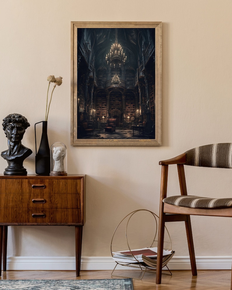 May include: A framed print of a dark, gothic library interior with a large chandelier hanging from the ceiling. The library is filled with bookshelves and a large armchair sits in the center of the room.