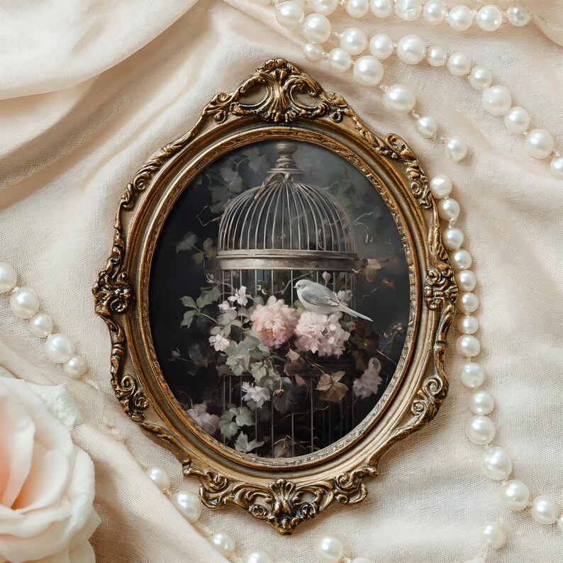 May include: A gold oval frame with a detailed floral design surrounds a painting of a white bird in a cage. The cage is surrounded by pink and white flowers and green leaves.