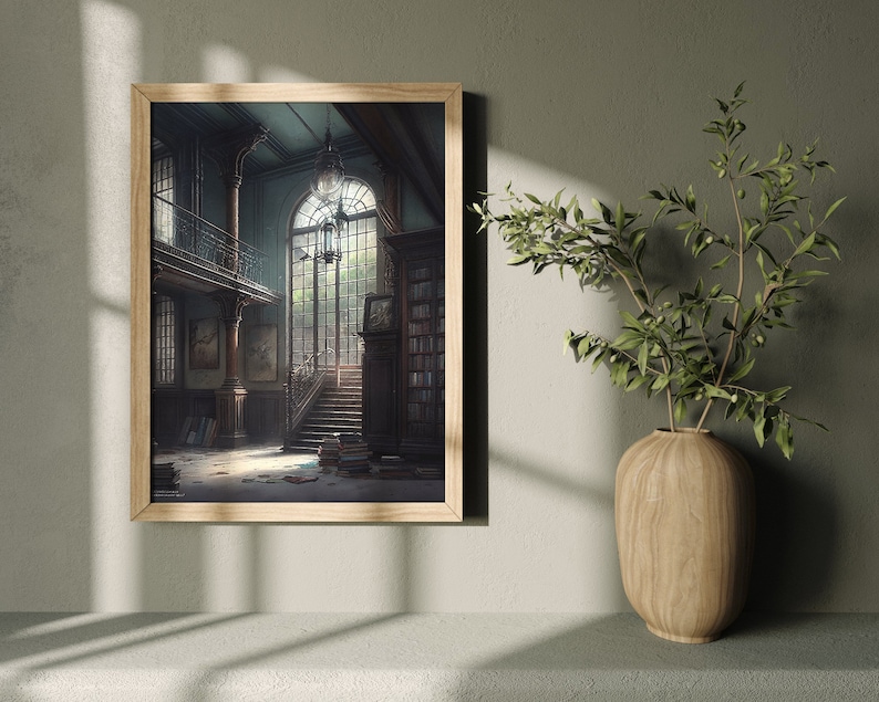 May include: A framed print of a painting depicting a grand, empty, and slightly dusty library interior with a large window, a staircase, and bookshelves. The painting is set against a light gray wall with a wooden frame.