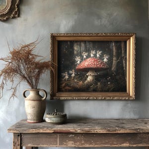 Fantasy-inspired print showing a circle of fairies around a red-capped mushroom in a moody woodland setting, ideal for mushroom decor enthusiasts.