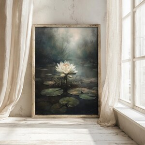 Cottagecore wall art capturing a water lily's subtle glow amidst the dark, evocative waters of a moody lake scene.