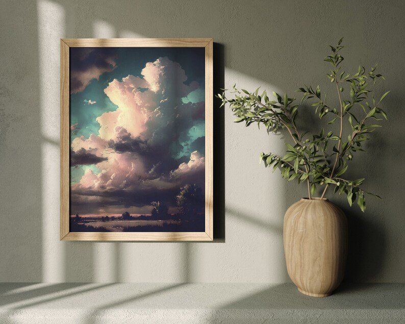 May include: A framed print of a landscape painting with a large, fluffy, pink and white cloud in a blue sky. The sky is dark blue in the background and the clouds are lighter in the foreground. The landscape is a field of green grass with trees in the distance.