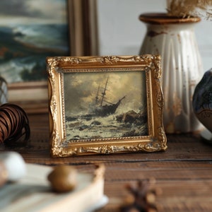Antique bathroom art featuring a dark nautical art print of a ship struggling in a storm, enhancing coastal gallery wall themes.