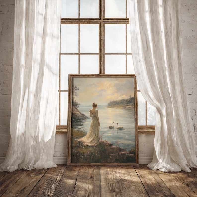 A moody nature art print featuring swans and a Victorian woman by a peaceful lake, perfect for spring decor, light academia aesthetics, or a vintage wall art collection.