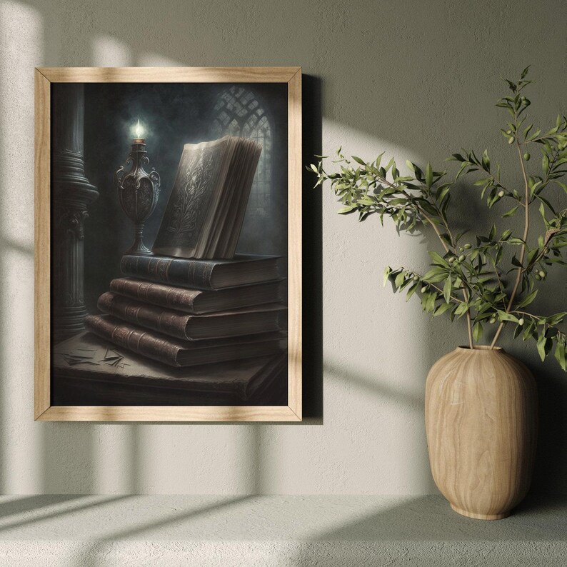 May include: A framed illustration of a stack of old books with a single open book on top. The books are illuminated by a candle in a candlestick. The background is a dark, shadowy room.
