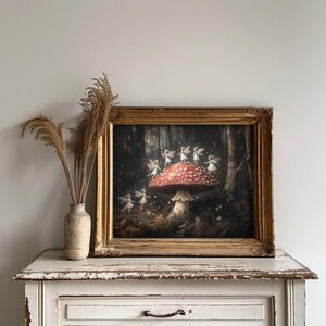 Dark cottagecore artwork featuring fairies dancing around a mushroom, set in a mystical forest, perfect for whimsical and woodland-themed decor.