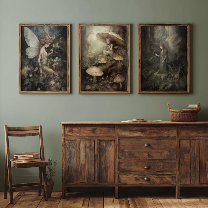 May include: Three framed art prints featuring fantasy scenes with fairies and mushrooms. The artwork has a vintage aesthetic with muted colors and detailed depictions of nature. The frames are made of light brown wood, and the overall theme is whimsical and enchanting.
