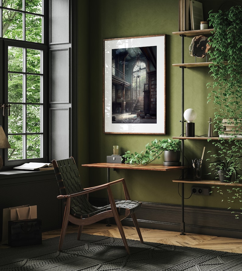 May include: A green wall with a framed black and white photograph of a grand staircase with a large window at the top. A wooden desk with a chair sits in front of the photograph. A shelf with plants and books is on the right side of the image.