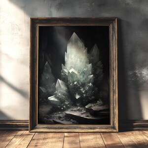 Dark moody crystal cave art print, framed in rustic gold, leaning against textured wall with dramatic shadows, gothic cottagecore decor.