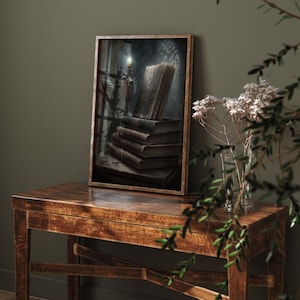 May include: A framed painting of a stack of old books with a lit candle in a candlestick on a dark background.