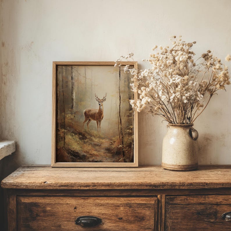 Vintage-inspired deer artwork in muted, earthy tones depicting a forest scene at dawn, available as a high-resolution digital download for dark academia or cottagecore home decor.