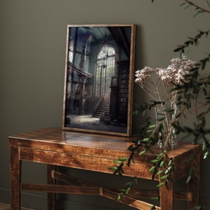 May include: A framed print of a dark, vintage interior with a grand staircase leading up to a large window. The room is filled with bookshelves and other antique furniture.