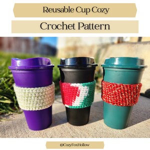 May include: Three reusable coffee cups with crochet cozies. The cups are purple, black, and teal, each with a different colored cozy. The text "Reusable Cup Cozy Crochet Pattern" is at the top of the image. The bottom of the image has the text "@CozyFoxHollow".